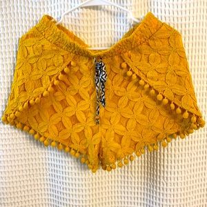 Tie shorts lined with pom poms